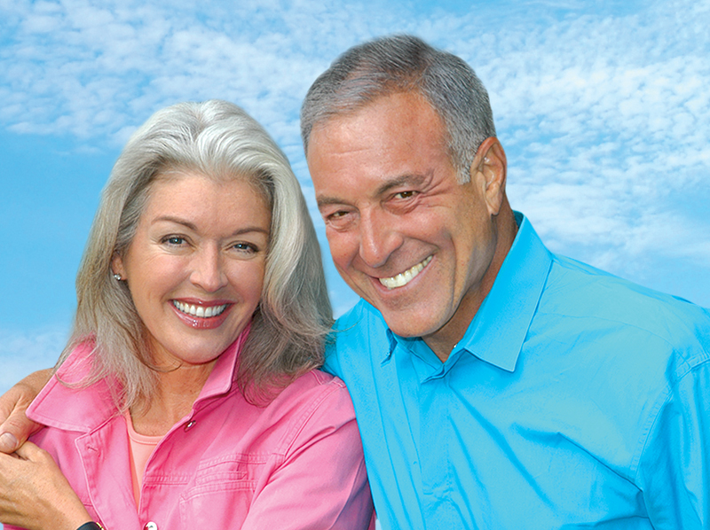 Happy Couple Showing Their Dental Implants Off